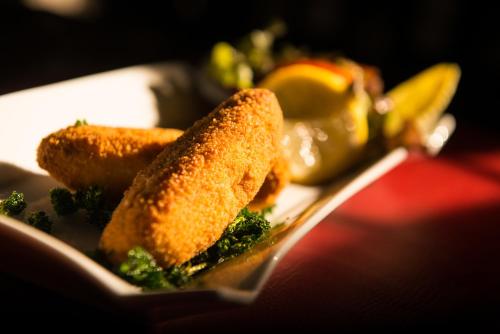 a close up of a plate of food with broccoli at Appart-Hotel Léopold Liège Centre in Liège