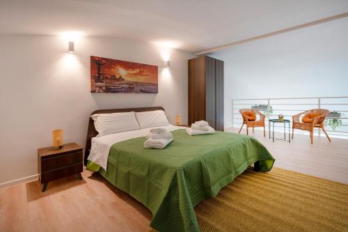 a bedroom with a bed with two towels on it at Sogno di Mare in Bari