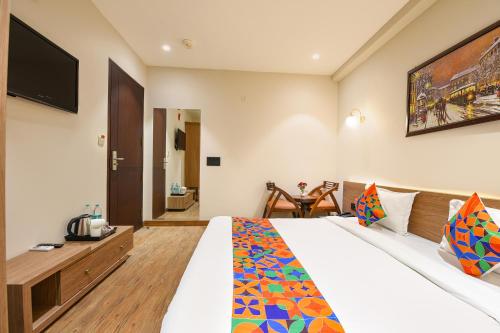 a hotel room with a bed and a television at FabHotel Prime Siya Residency - Nr Karkardooma Metro Station in New Delhi