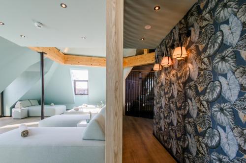 a room with two beds and a wall with a mural at 4K in Wangen im Allgäu