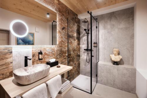 a bathroom with a shower and a sink at Hotel Julian Alps in Zgornje Gorje
