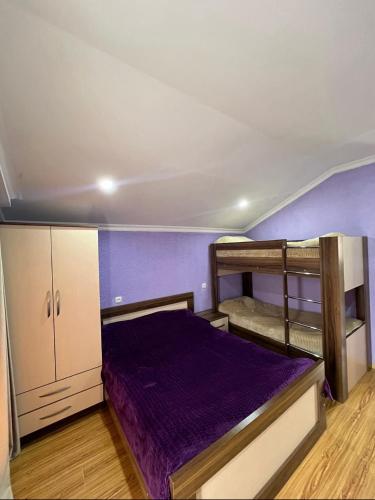 a bedroom with two bunk beds and purple walls at GB cottages Bakuriani in Bakuriani