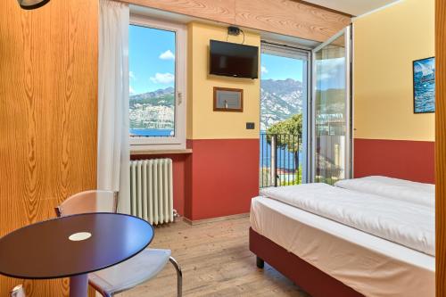 En eller flere senge i et værelse på Hotel Luna Rossa