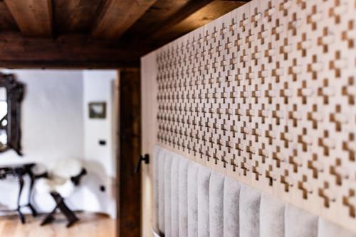 a room with a brick wall with a wooden ceiling at Hotel Julian Alps in Zgornje Gorje