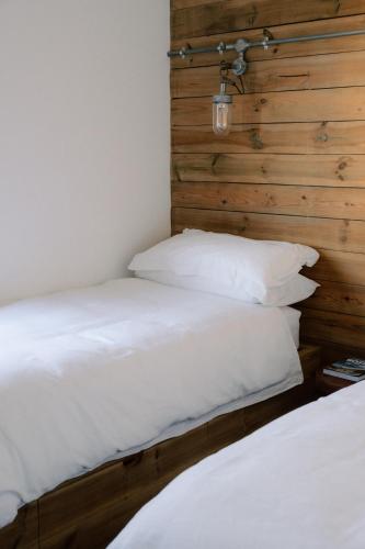 two beds sitting next to each other in a bedroom at Cabin at Mackay's in Durness