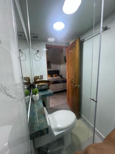 a bathroom with a toilet and a sink at Casa Boutique La Corona Medellin in Envigado