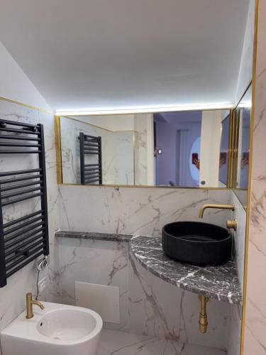 a bathroom with a sink and a mirror at Taorminas Sun Central Boutique Guesthouse & Suites in Taormina