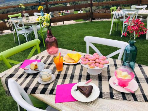 a picnic table with plates of food on it at Country House S'Ozzastru in Dorgali