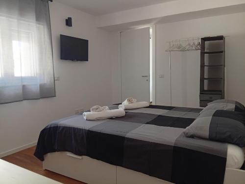 a bedroom with a bed with two towels on it at Al Settimo Chilometro in Gioia del Colle