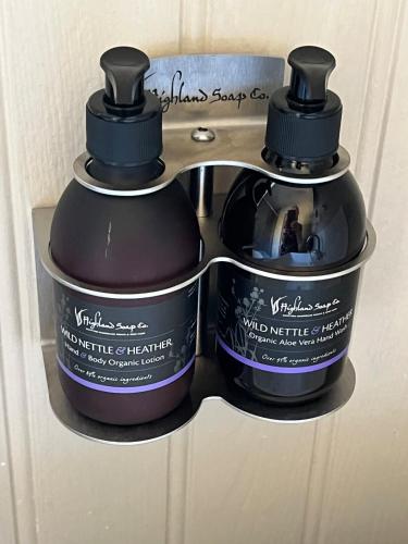 two bottles of wild medicine on a door rack at Clianba- 3 bedroom Highland home from home in Spean Bridge