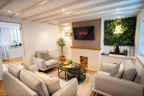 a living room with couches and a fire place at Stylish 2 Bedroom Cottage with Hot Tub and Parking in Bewdley