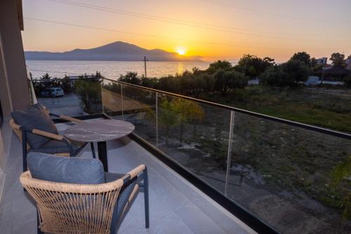a balcony with a table and a view of the ocean at Tris3 Hotel in Vlorë