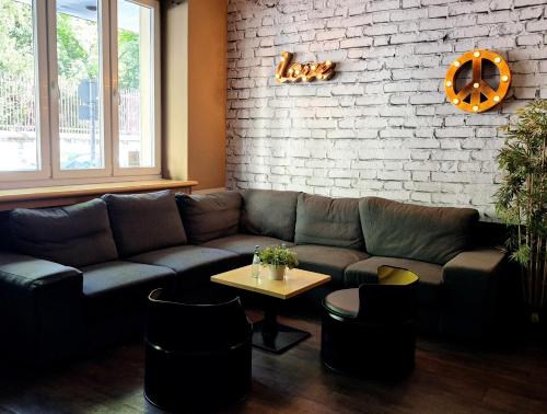 a living room with a couch and a table at Sonata City Hotel in Cologne