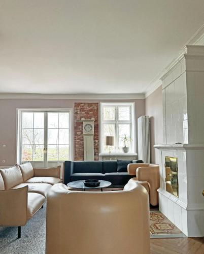 a living room with a couch and a fireplace at Historisches Bauernhaus Fehmarn in Strukkamp auf Fehmarn