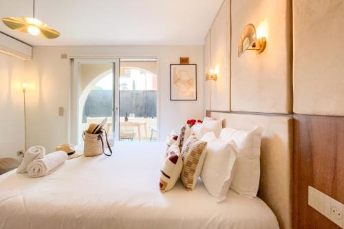 a bedroom with a bed with white pillows on it at Studio Place des Lices - K1 in Saint-Tropez