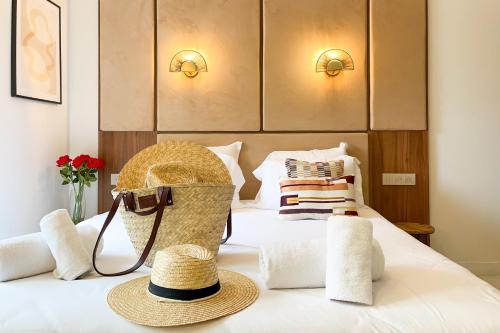 a hotel room with a bed with a hat on it at Studio Place des Lices - K1 in Saint-Tropez