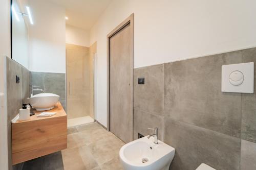 a bathroom with a sink and a toilet and a shower at Dimora Bassignano in Cuneo
