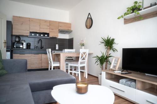 a living room with a couch and a table at Apartmán Slunce in Poděbrady