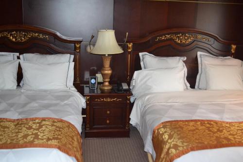 a hotel room with two beds and a lamp at Radisson Hotel Toronto Airport West in Mississauga
