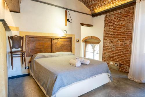a bedroom with a bed with two towels on it at lovingenoa Light - Passion in Genoa