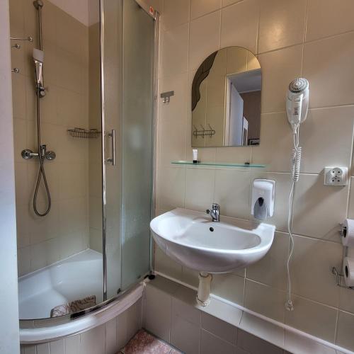 a bathroom with a sink and a shower at Skarb Morza in Międzyzdroje