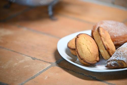 a plate of different types of donuts on a table at Agriturismo Il Poeta Contadino in Merine