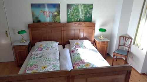 a bedroom with a wooden bed and two night stands at Ferienwohnung Melba in Traben-Trarbach