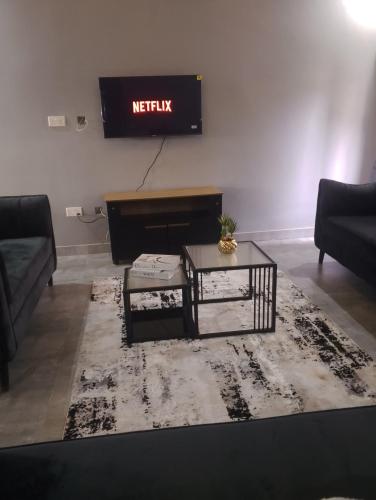 a living room with a piano and a rug at Fully serviced apartments solwezi in Solwezi