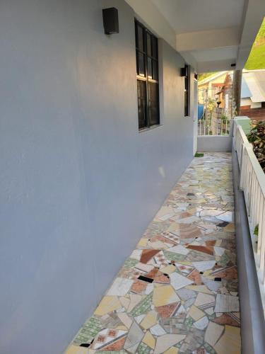 a hallway with a tiled floor with a window at Hidden gem in Massacre Dominica in Massacre