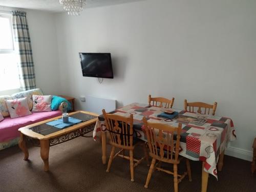 a living room with a table and a couch at Cosy Cork - House - Sleeps 4 - City Centre in Cork