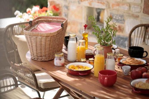 a wooden table with food and drinks on it at Phoenicia Nature Naxos in Kastraki