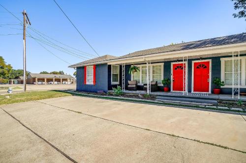 a blue and red house with red doors at Granbury Getaway - 3 Bedroom in Granbury