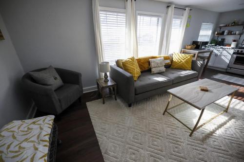 a living room with a couch and a chair at Granbury Loft - 1 Bedroom in Granbury