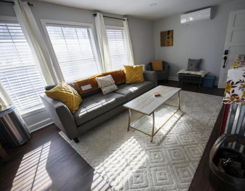 a living room with a couch and a table at Granbury Loft - 1 Bedroom in Granbury
