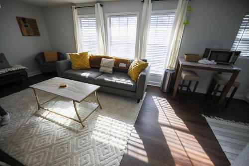 a living room with a couch and a table at Granbury Loft - 1 Bedroom in Granbury
