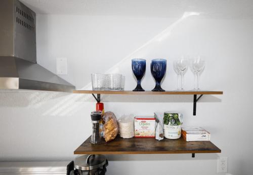a shelf with wine glasses and other items on it at Granbury Loft - 1 Bedroom in Granbury