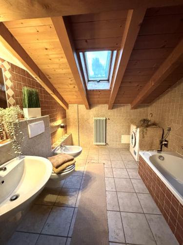 a large bathroom with two sinks and a window at Casa Lucrezia by Gottschalk in Colico