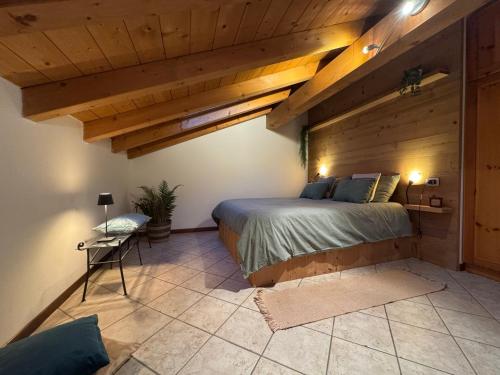 a bedroom with a bed in a room with wooden ceilings at Casa Lucrezia in Colico