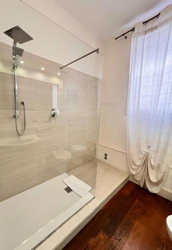 a bathroom with a shower with a glass door at Avanguardia Art Club in Ferrara