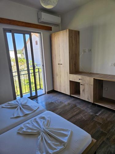 a bedroom with a bed and a desk and a window at Villa2 in Golem