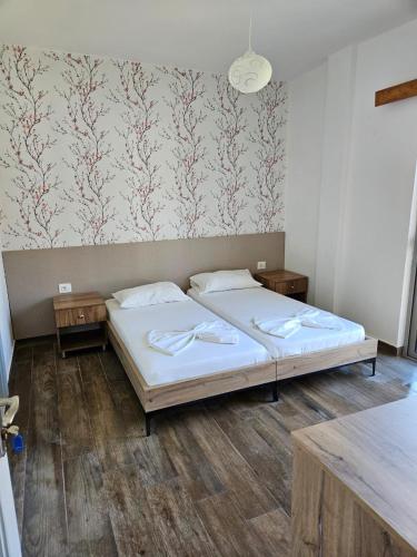 a bedroom with a bed and a wall with wallpaper at Villa2 in Golem