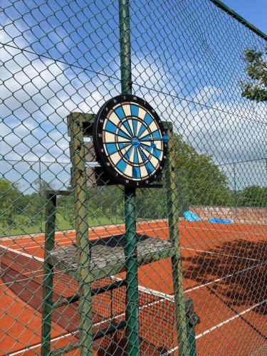 a sign on a tennis court behind a fence at Vikendica S, Alibegovac in Petrovaradin