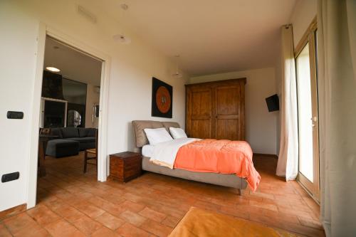 a bedroom with a bed and a living room at Agriturismo Il Poeta Contadino in Merine