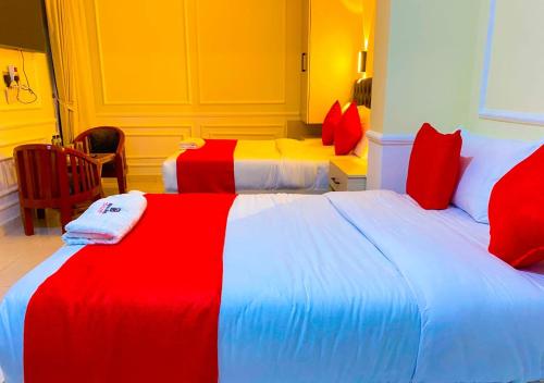 a hotel room with two beds with red and blue sheets at Bijou Hotel in Nairobi