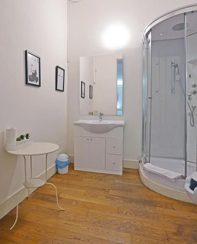 a white bathroom with a sink and a shower at Avanguardia Art Club in Ferrara