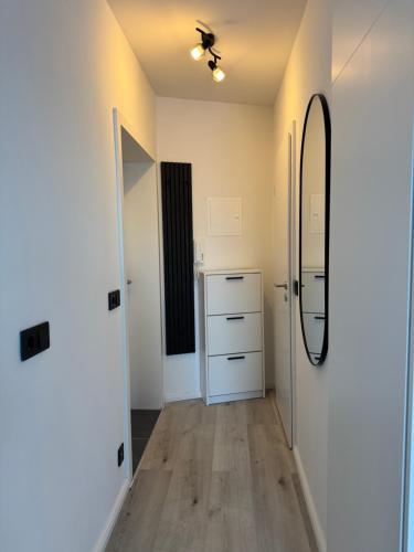 a room with a hallway with a mirror and a dresser at Atlantic 003- Exclusive Ferienwohnung mit Pool, Sauna und Fitnessbereich im Haus in Cuxhaven