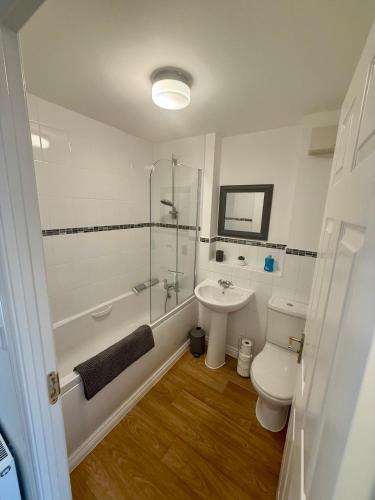 a bathroom with a shower toilet and a sink at The Lakes in Stockingford