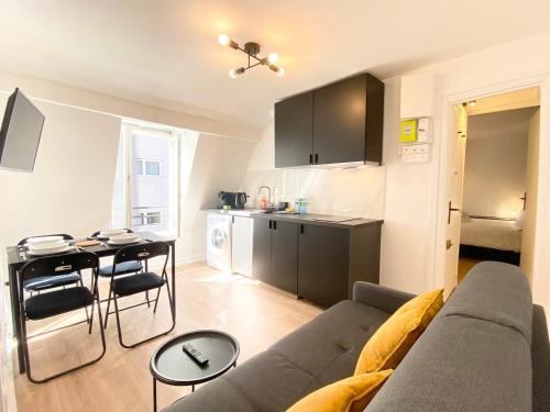 un salon avec un canapé et une table et une cuisine dans l'établissement GuestReady - Cozy nest in Salpêtrière, à Paris