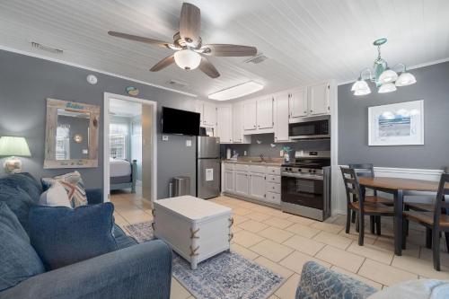 a living room with a blue couch and a kitchen at Sea & Sun 204 by Vacation Homes Collection in Gulf Shores