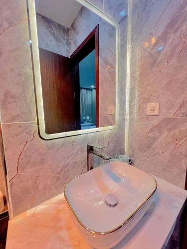 a bathroom with a white toilet and a mirror at Anna Belle Đồi Rồng Hotel - Homestay chuỗi HPT Home Hải Phòng in Kon Rung (1)